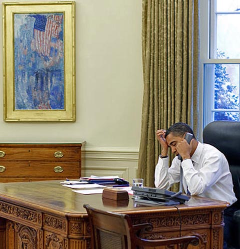 President Barrack Obama at his White House Desk next to Childe Hassam's Avenue in the Rain