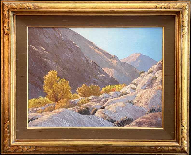John W Hilton, Fall in the Canyon, a scene with colorful vegitation in browns, bronzes, yellows and oranges nestled between a sunslit hill and one in shadow in Hellhole Canyon in Anza Borrego State Park