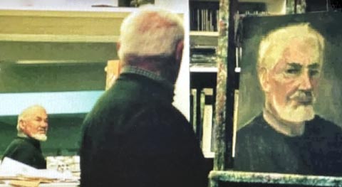 Maurice Lapp photographed as he painted his self portrait while looking at his image in a mirror.