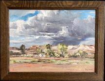Joshua Meador, South Nevada, a desert scene with large cumulous storm clouds and sunlilght desert vegitation forground