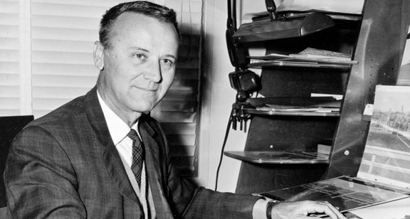 Photo of Al Dempster at his desk at Disney Studios